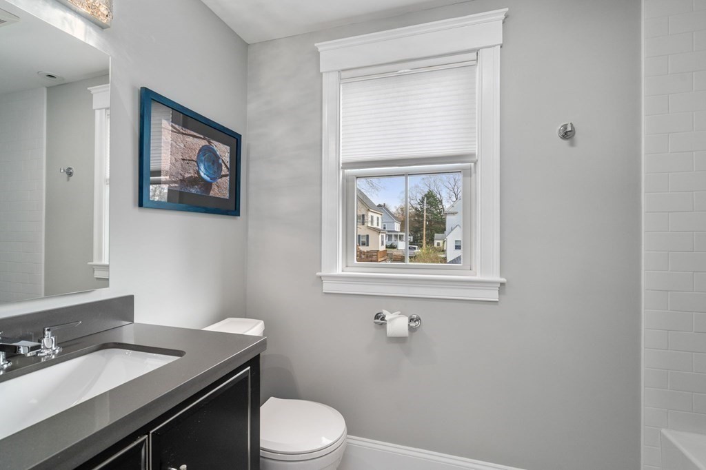 43 O'Neil Street Hudson, MA 01749 - Photo 28 of 39 a bathroom with a granite countertop toilet a sink and mirror