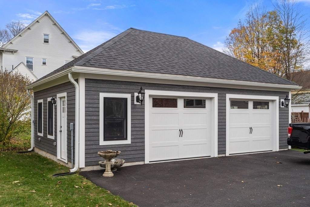 43 O'Neil Street Hudson, MA 01749 - Photo 4 of 39 a front view of a house with a garage