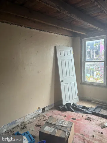 a view of a room that has a rug and a window