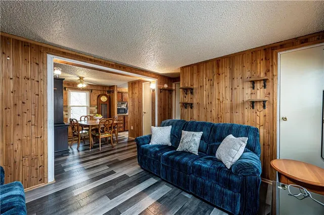 a kitchen with stainless steel appliances granite countertop a refrigerator a stove and a sink