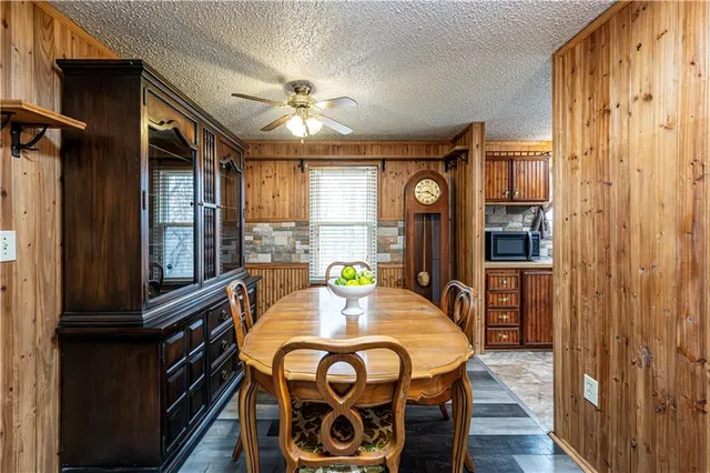 a kitchen with stainless steel appliances granite countertop a refrigerator a sink and a stove with wooden floor