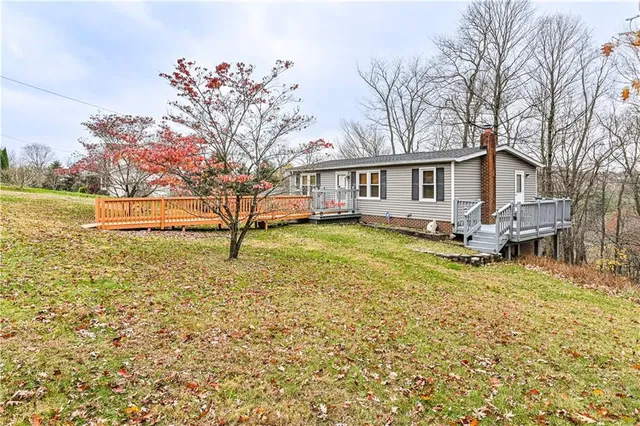 a living room with furniture a lamp and a large window