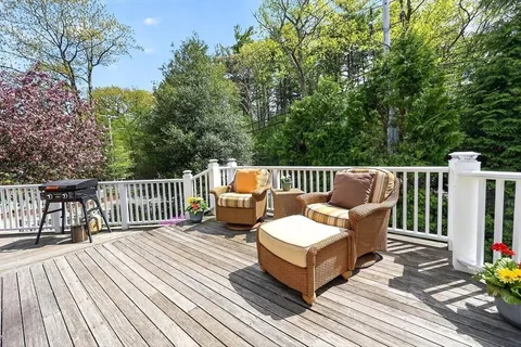 a view of a wooden deck with furniture
