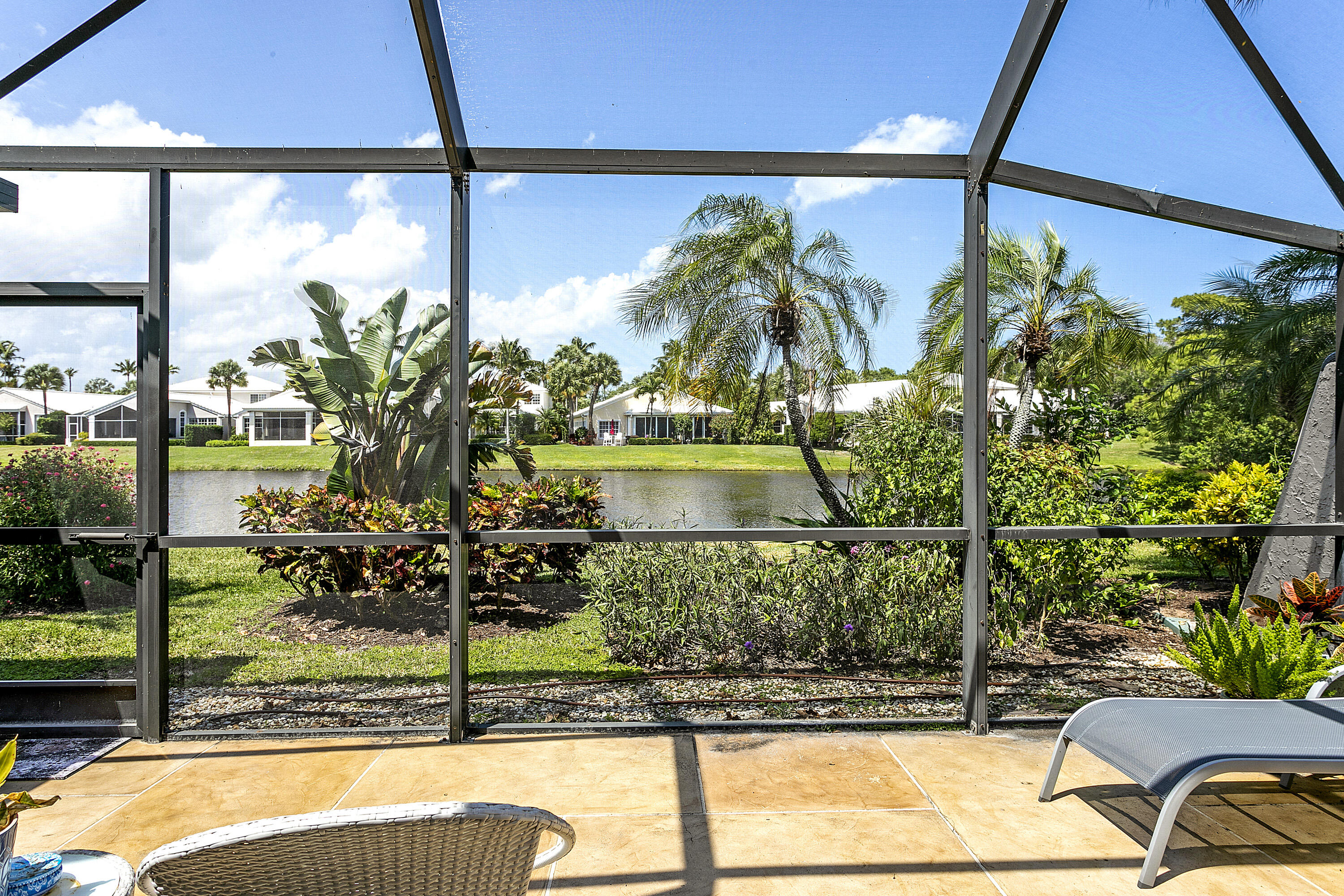 3697 Cape Pointe Circle Jupiter, FL 33477 - Photo 1 of 55 Lake view from Screen-in porch
