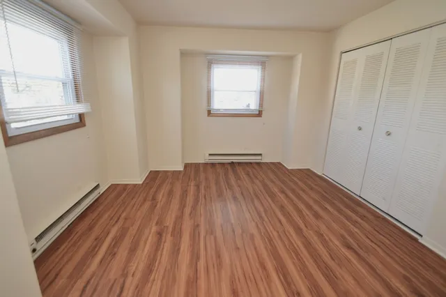 a view of a room with wooden floor and window