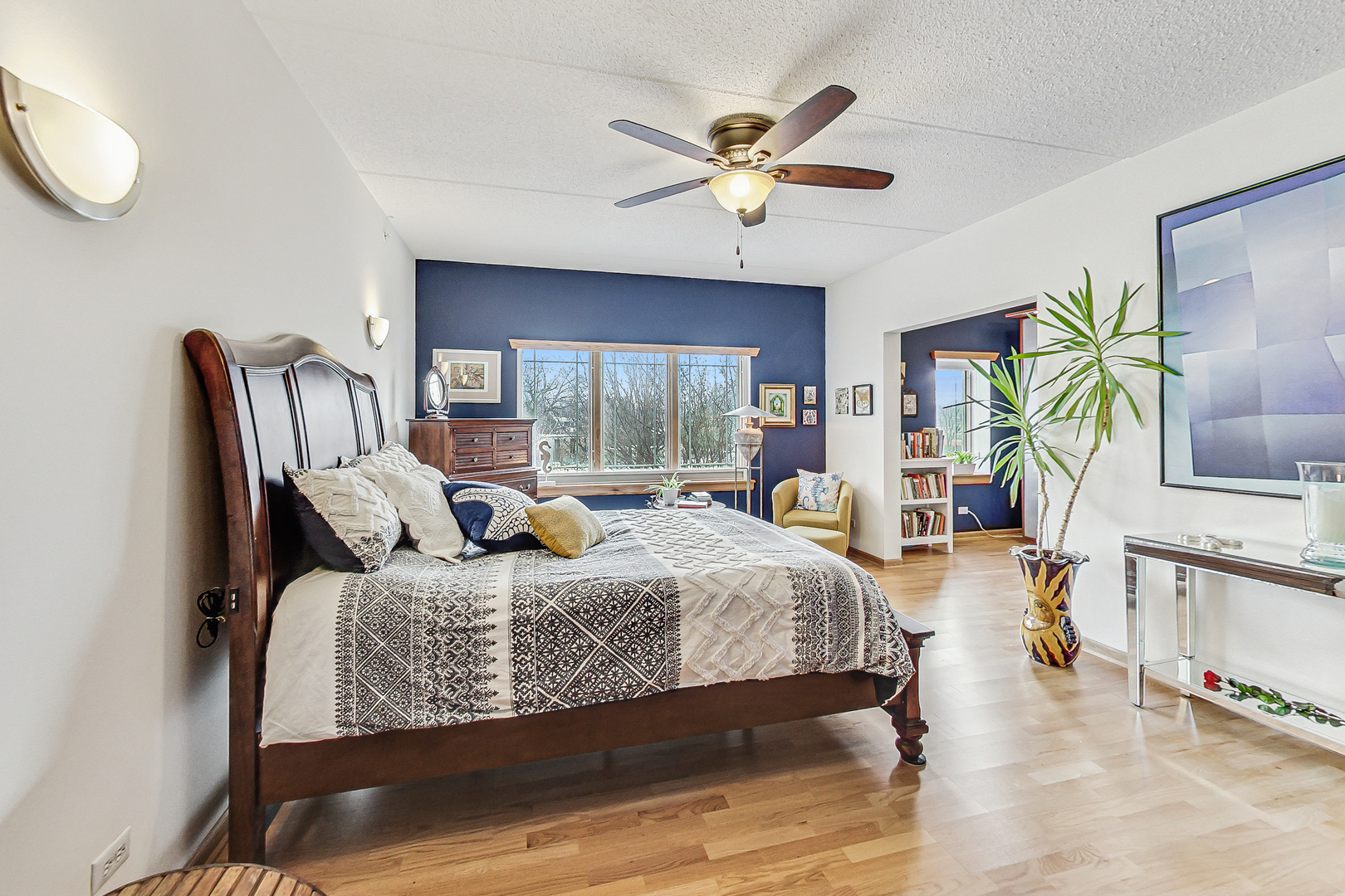 911 Busse Highway, Unit 204 Park Ridge, IL 60068 - Photo 14 of 31 a bedroom with a bed a chandelier and next to a window