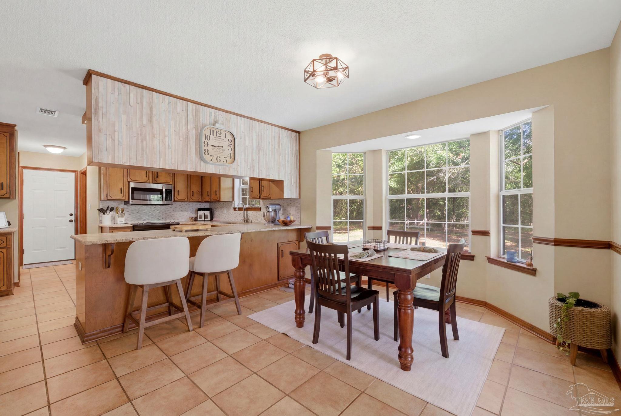 6870 Martin Road Milton, FL 32570 - Photo 8 of 48 a view of a dining room with furniture