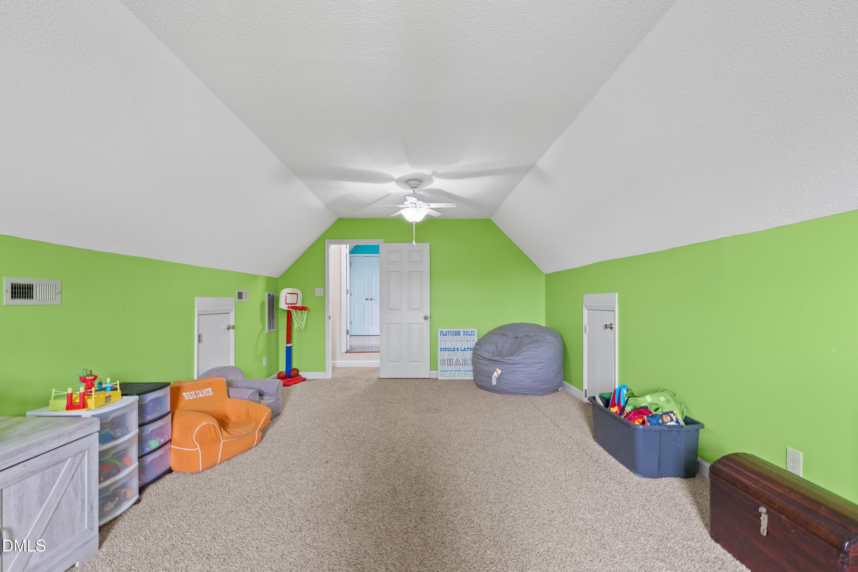 724 Iris Bryant Road Dunn, NC 28334 - Photo 16 of 22 a bedroom with a bed and a chandelier