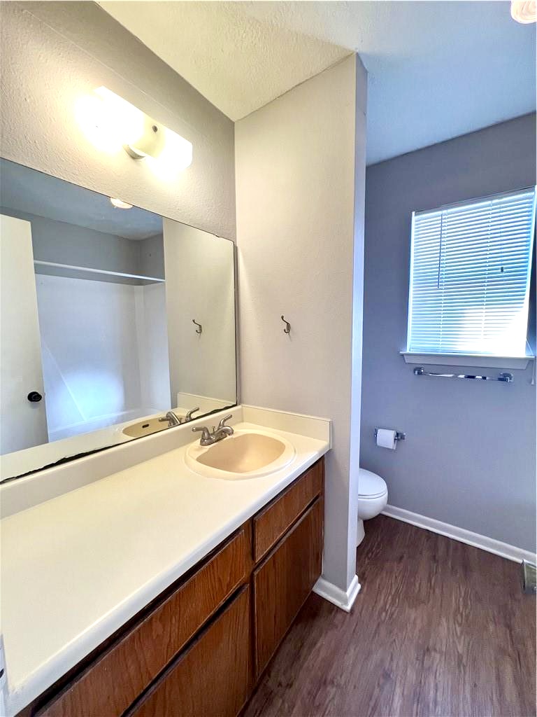 918 Spring Loop, Unit A College Station, TX 77840 - Photo 11 of 12 a spacious bathroom with a granite countertop sink toilet and mirror