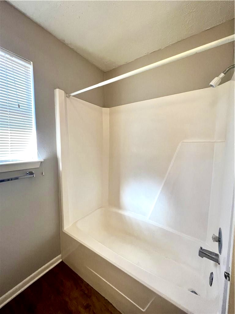 918 Spring Loop, Unit A College Station, TX 77840 - Photo 12 of 12 a bathroom with a bathtub and a shower