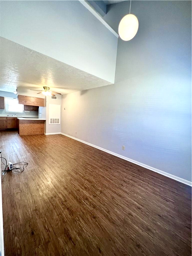 918 Spring Loop, Unit A College Station, TX 77840 - Photo 4 of 12 an empty room with wooden floor and windows