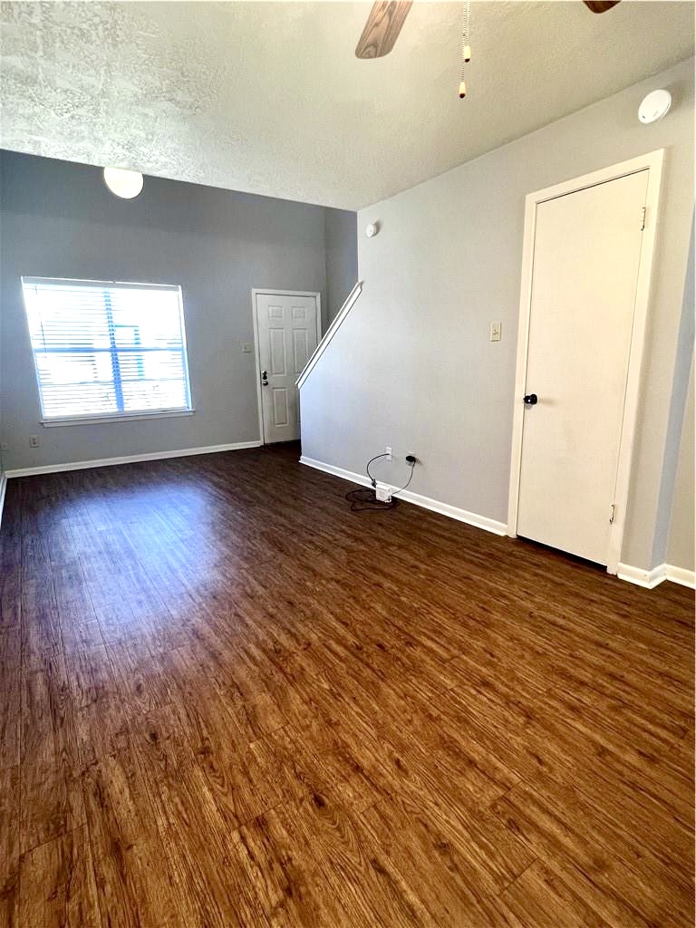 918 Spring Loop, Unit A College Station, TX 77840 - Photo 5 of 12 an empty room with wooden floor and windows