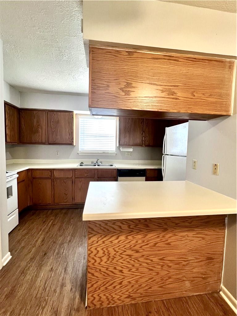 918 Spring Loop, Unit A College Station, TX 77840 - Photo 6 of 12 a large white kitchen with wooden floor