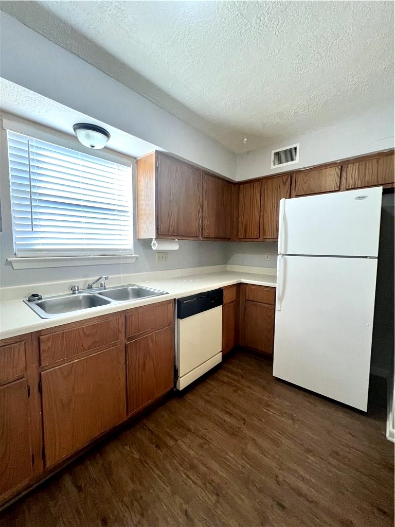 918 Spring Loop, Unit A College Station, TX 77840 - Photo 8 of 12 a kitchen with sink a refrigerator and white cabinets