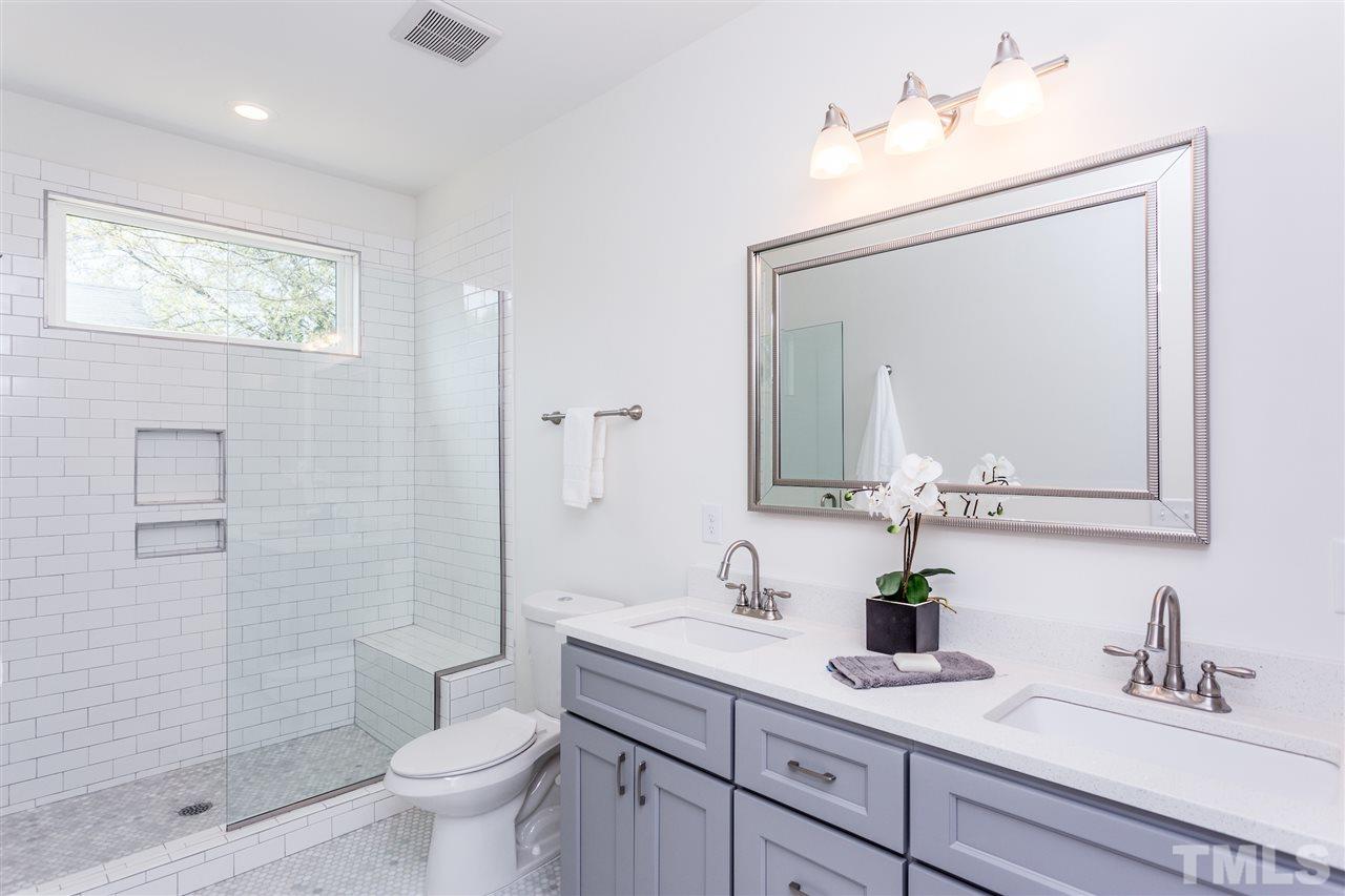 811 Postell Street Raleigh, NC 27601 - Photo 13 of 20 a bathroom with a toilet a sink a mirror and shower