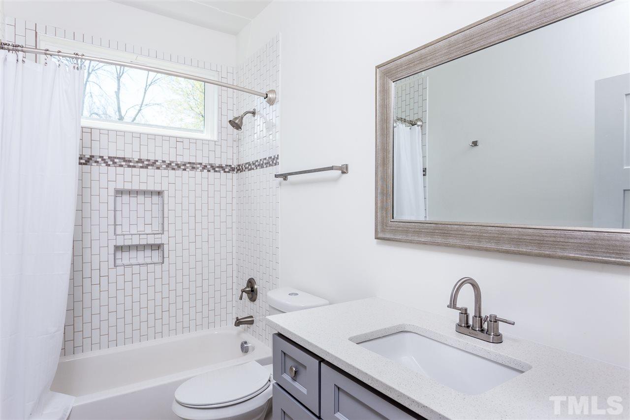 811 Postell Street Raleigh, NC 27601 - Photo 16 of 20 a bathroom with a sink toilet a mirror and shower