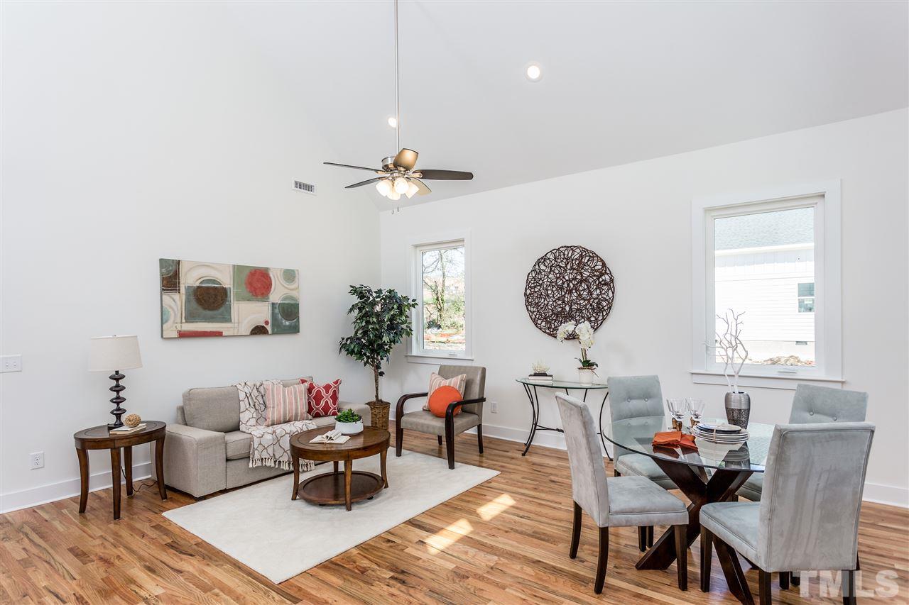 811 Postell Street Raleigh, NC 27601 - Photo 4 of 20 a living room with furniture a window and a chandelier