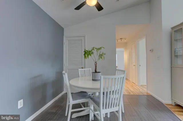a dining room with furniture and wooden floor