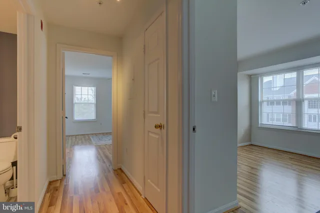 a view of hallway with wooden floor