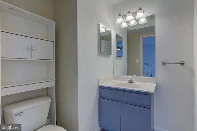 a bathroom with a toilet sink and mirror