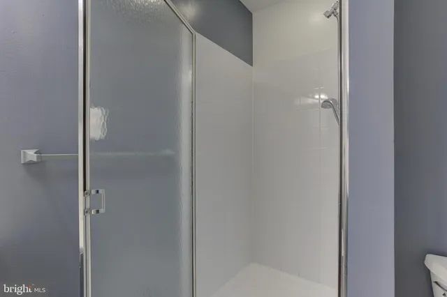 a bathroom with a glass shower door