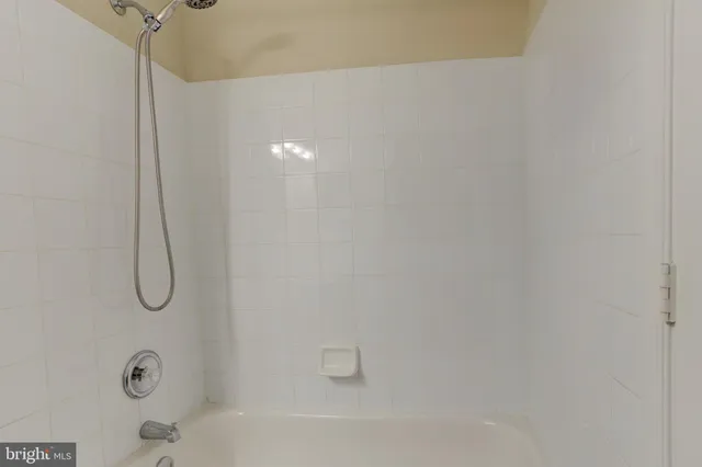 a bathroom with a bath tub with a shower