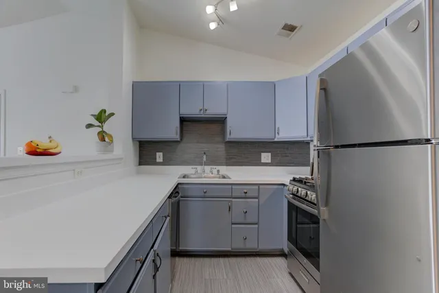 a kitchen with a sink stainless steel appliances and cabinets