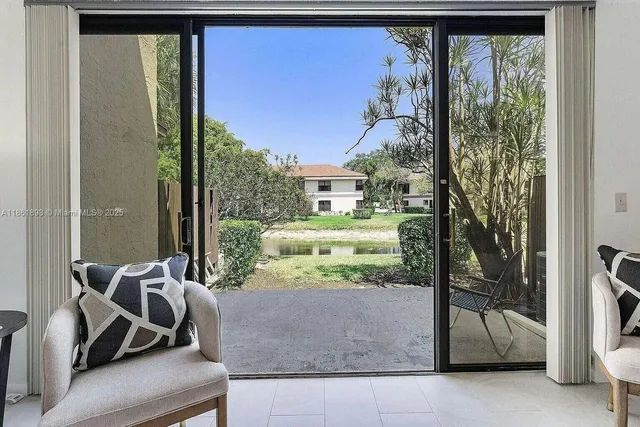 a room with furniture and a floor to ceiling window