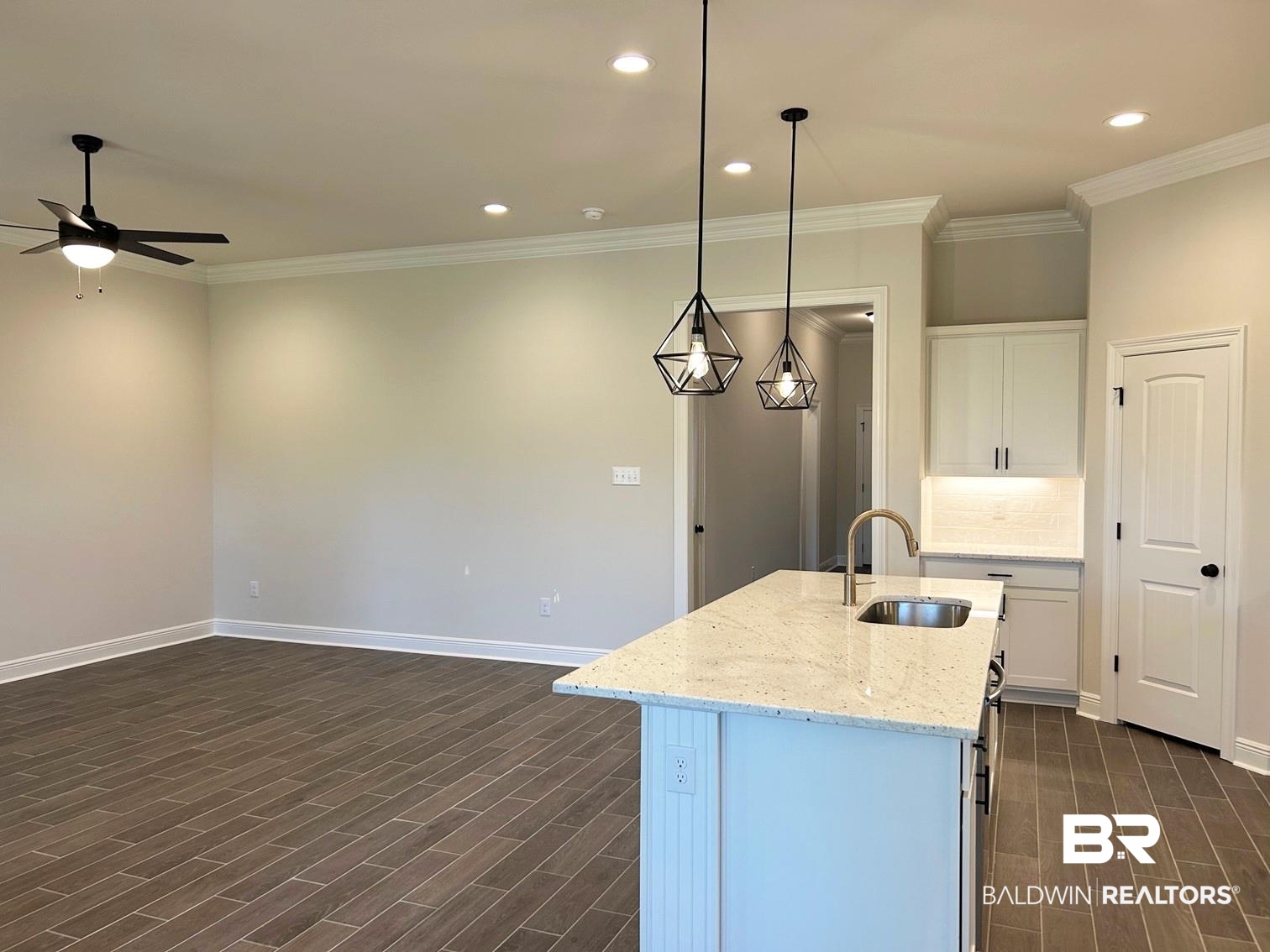 868 Sumter Loop Foley, AL 36535 - Photo 4 of 16 Kitchen with sink, white cabinetry, decorative light fixtures, and dark hardwood / wood-style floors
