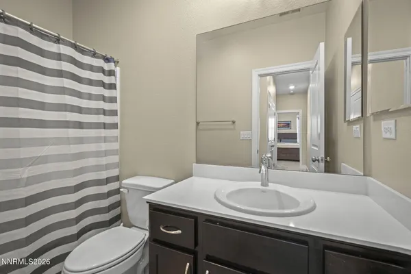 a bathroom with a sink toilet and mirror