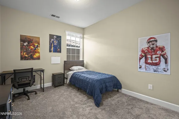 a bedroom with a bed and a workspace