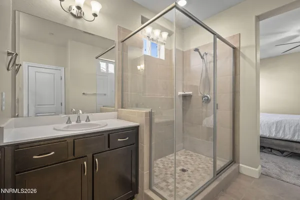 a bathroom with a shower sink and mirror
