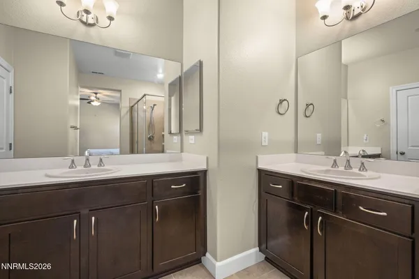 a bathroom with a double vanity sink and mirror