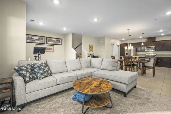 a living room with furniture kitchen view and a table