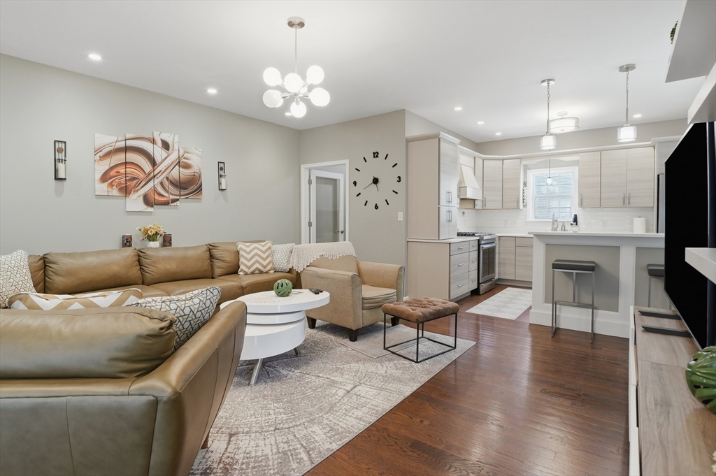 112 Pineland Avenue Worcester, MA 01604 - Photo 7 of 38 a living room with furniture kitchen view and a chandelier