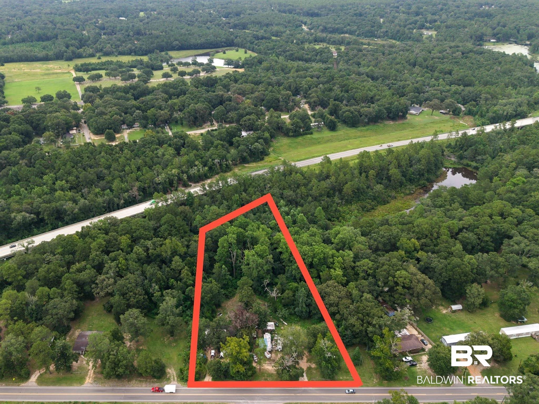 5386 Lott Road Eight Mile, AL 36613 - Photo 28 of 35 Aerial view of property and surrounding area featuring property parcel outlined and a forest