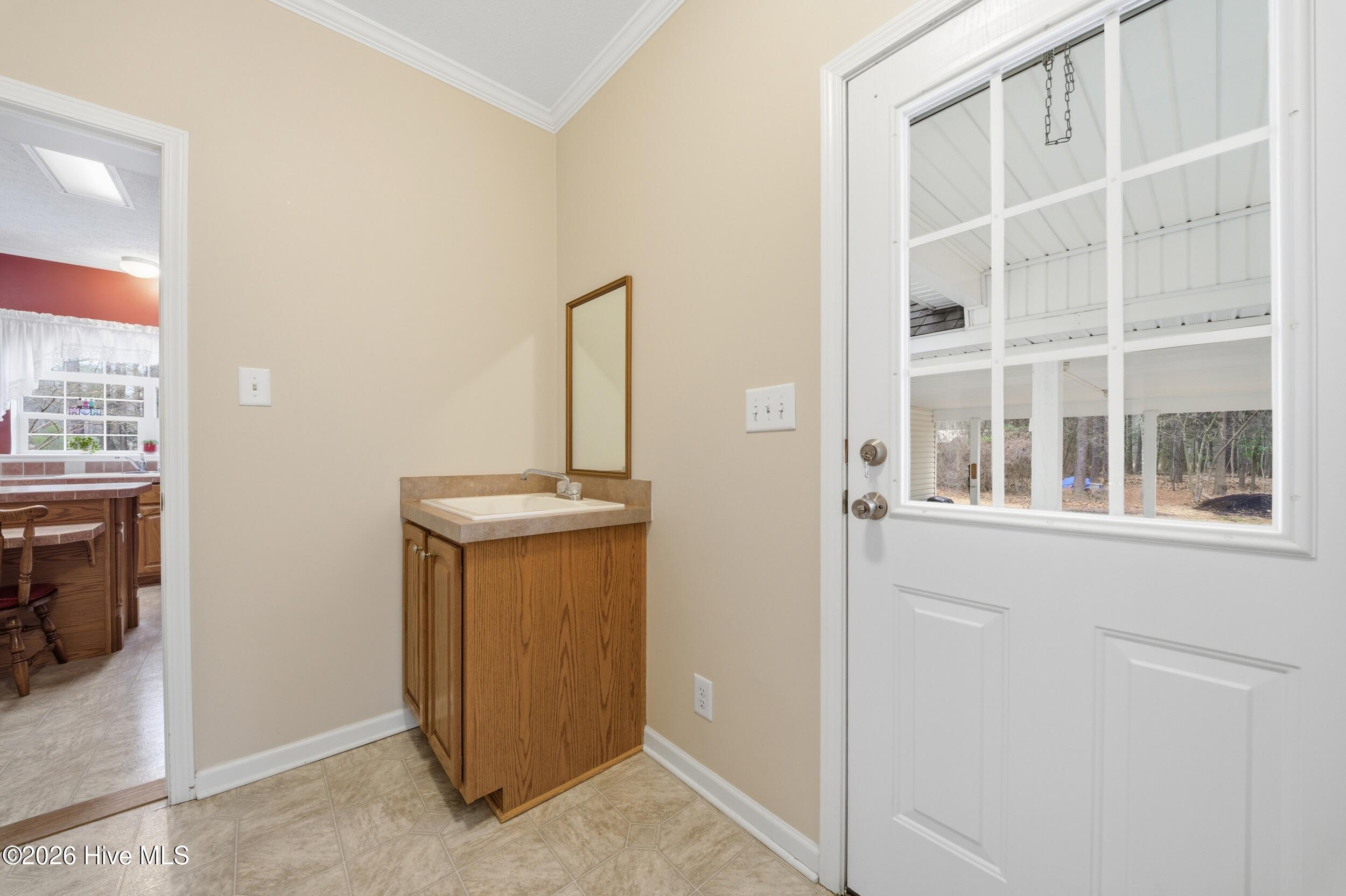 213 Shoshone Trail Edenton, NC 27932 - Photo 29 of 48 side door entry with utility sink, washer, dryer & half bath