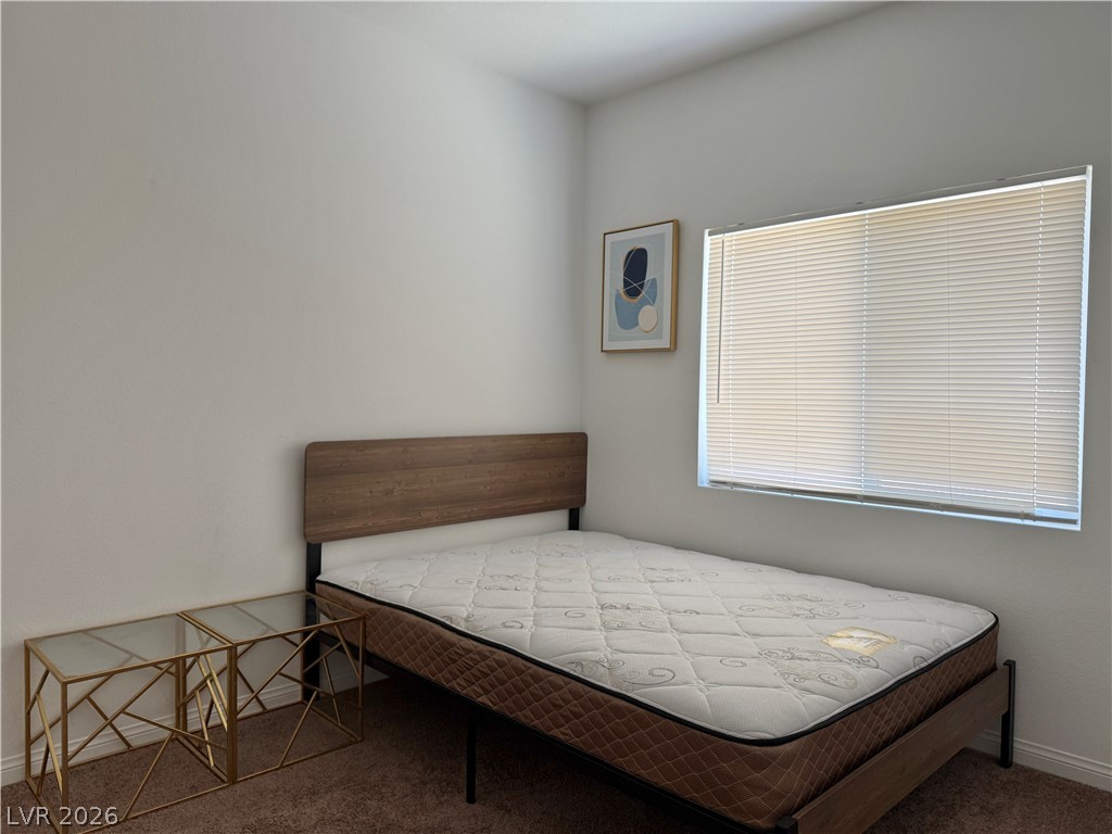 7777 South Westwind Road Las Vegas, NV 89139 - Photo 18 of 46 Well-lit and tranquil, this bedroom provides a peaceful retreat with ample natural light.