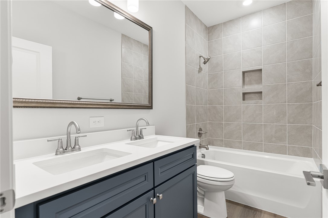 141 Rickys Path Easley, SC 29642 - Photo 33 of 40 This bathroom offers a contemporary vanity with double sinks and a sleek tiled shower.