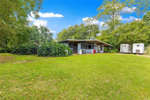a view of house that has a big yard