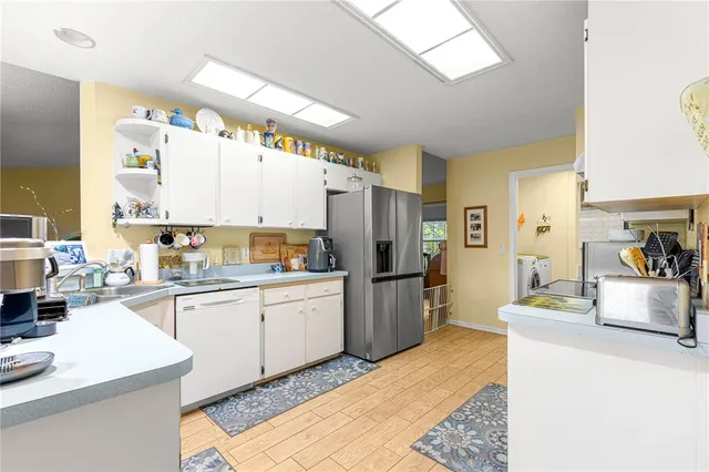 a kitchen with stainless steel appliances granite countertop a refrigerator and a stove top oven