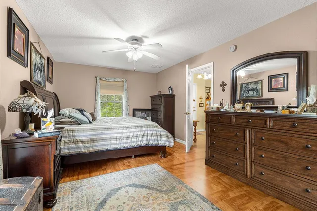 a bedroom with a large bed and a chandelier