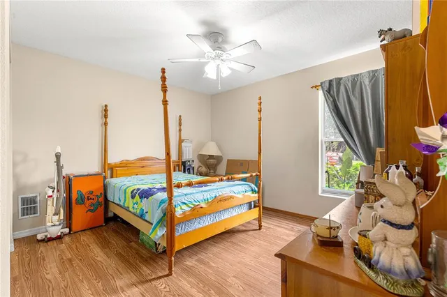 a bedroom with a bed dresser and a large mirror