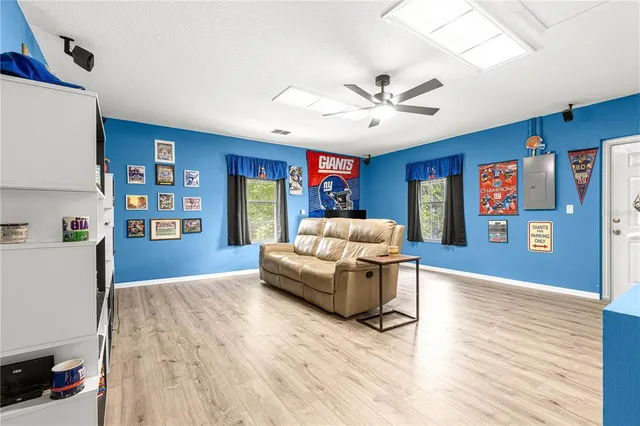 a living room with furniture flat screen tv and kitchen view
