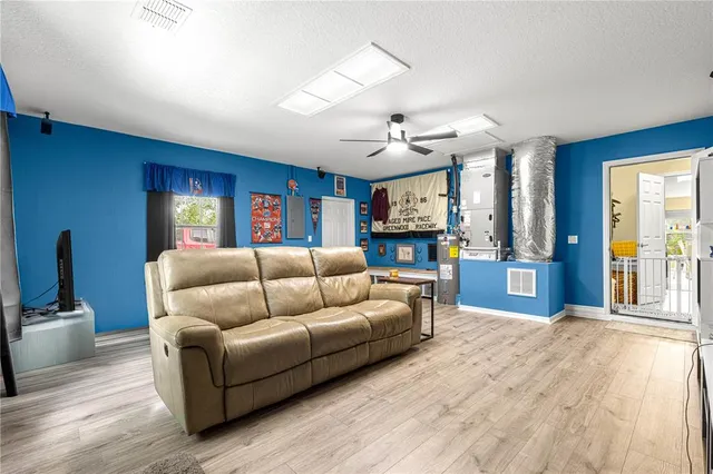 a living room with furniture and a floor to ceiling window
