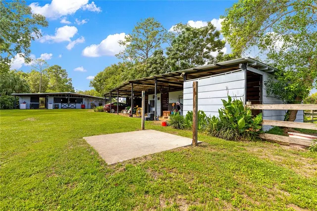 a view of a house with backyard porch and sitting area