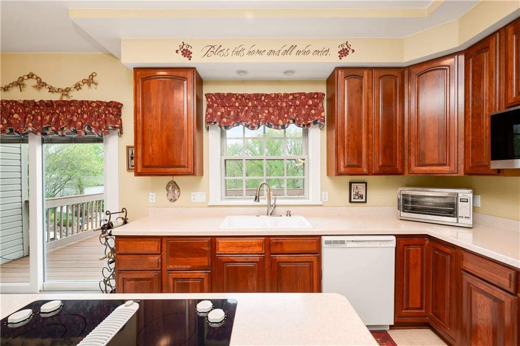 829 Hartzell School Road New Brighton, PA 15066 - Photo 7 of 50 a kitchen with stainless steel appliances a sink window and cabinets