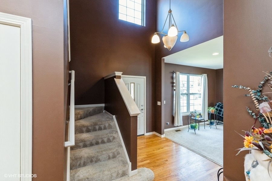 9675 Newton Road Huntley, IL 60142 - Photo 2 of 18 a view of a livingroom with furniture and staircase