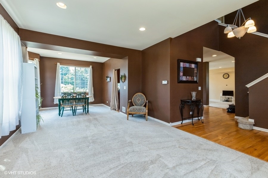 9675 Newton Road Huntley, IL 60142 - Photo 3 of 18 a view of a livingroom with furniture and floor to ceiling window