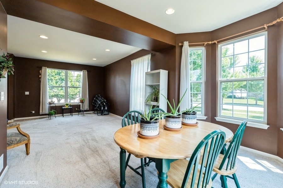 9675 Newton Road Huntley, IL 60142 - Photo 4 of 18 a view of a dining room with furniture window and outside view